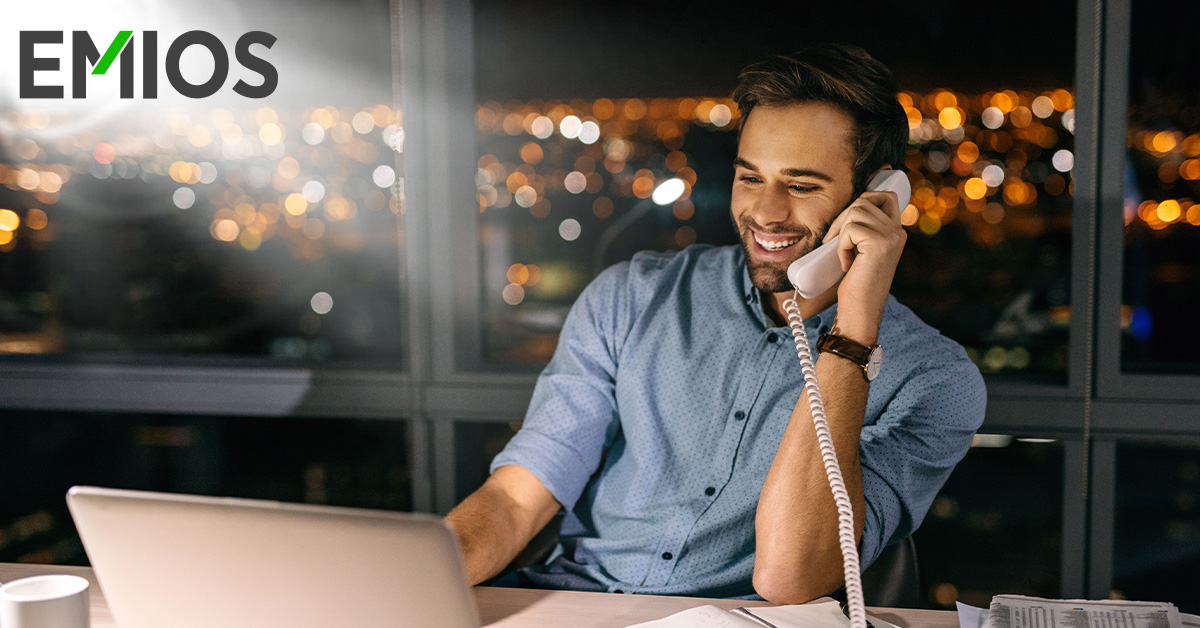 Smiling businessman working at his office desk late at night